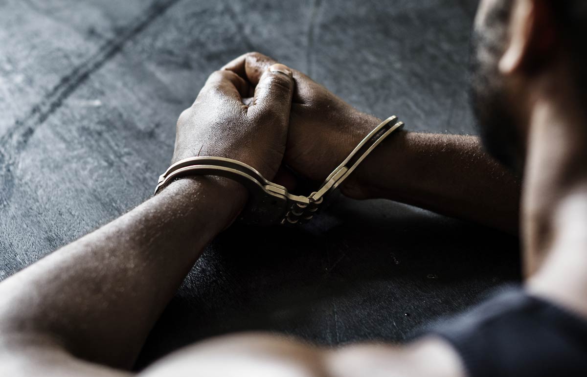 An arrested man with handcuffs on